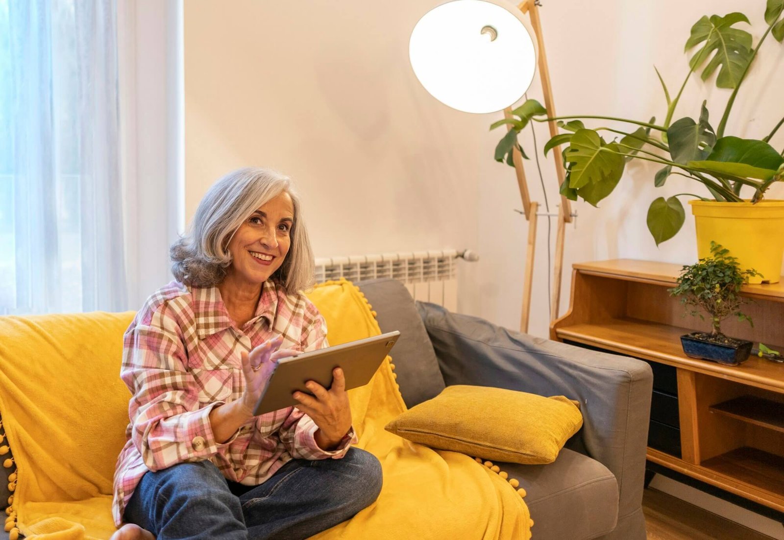 gray-haired-mature-woman-smart-home-home-control-on-tablet-use-smart-home-app.jpg