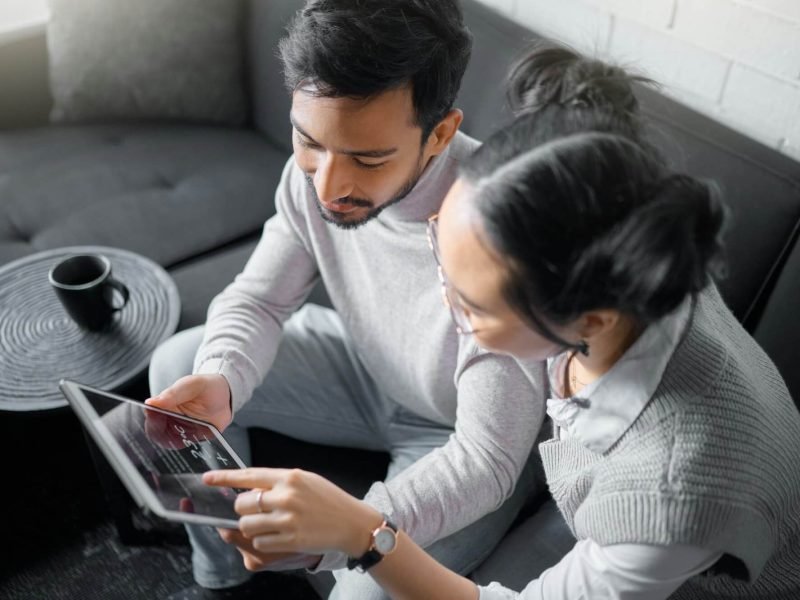 tablet-sofa-and-couple-with-smart-home-technology-for-thermostat-heating-apartment-security-netwo.jpg